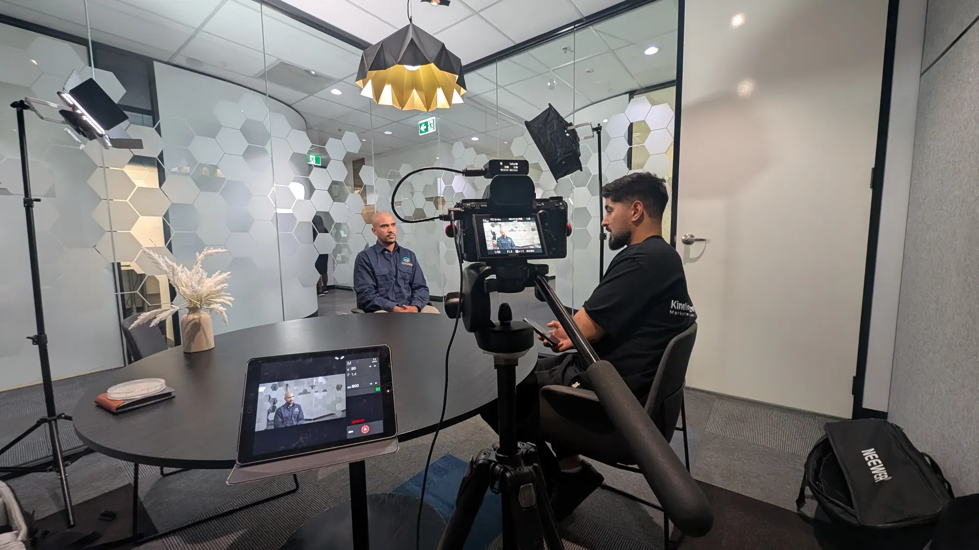 Cameras and lights set up for a client interview in an office