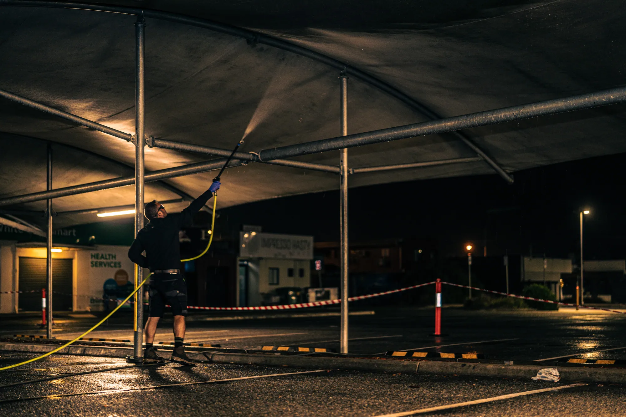 Pressure washing a shade structure at night