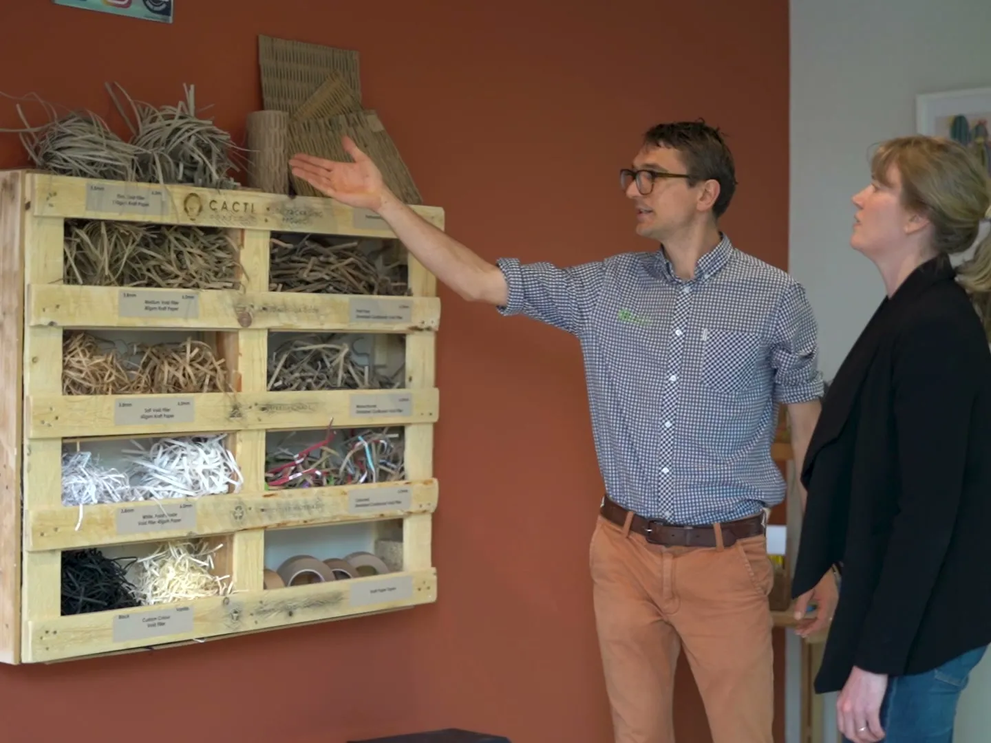 A founder showing a client his product range in the workshop