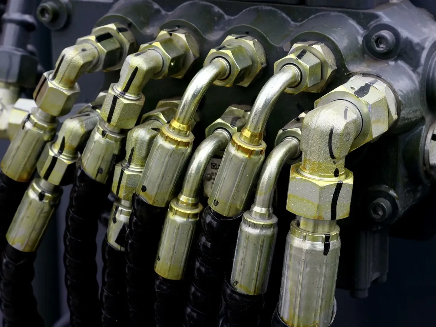 Close-up of hydraulic hose fittings on machinery