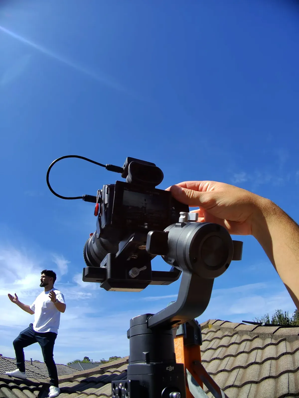 Filming a client on a rooftop with a gimbal camera