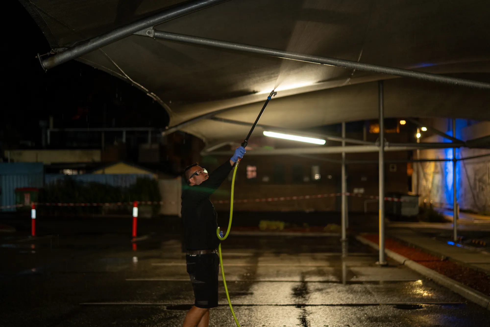 Cleaning under the shade sails in a car park