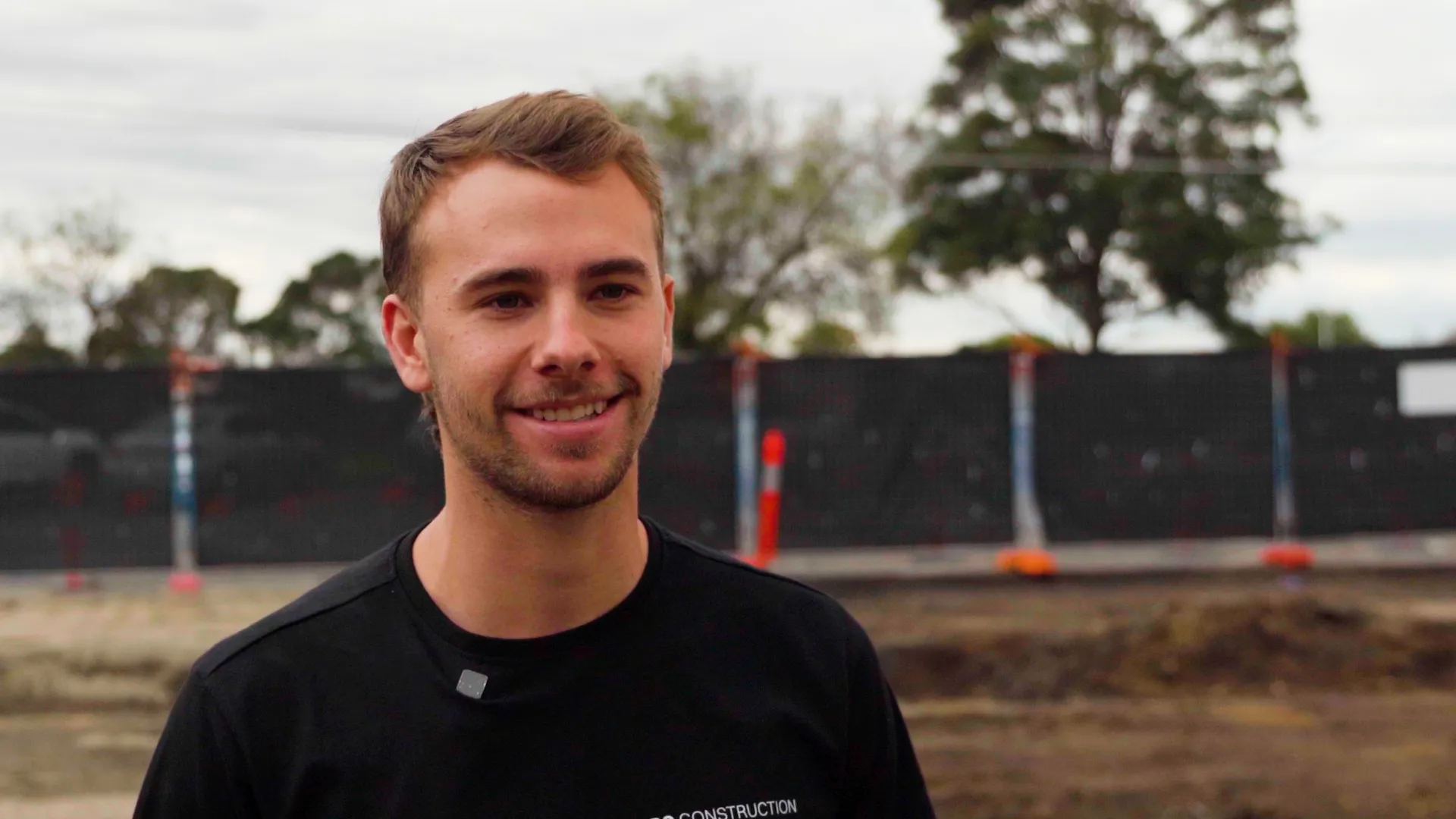A young tradie smiling on the Reservoir site
