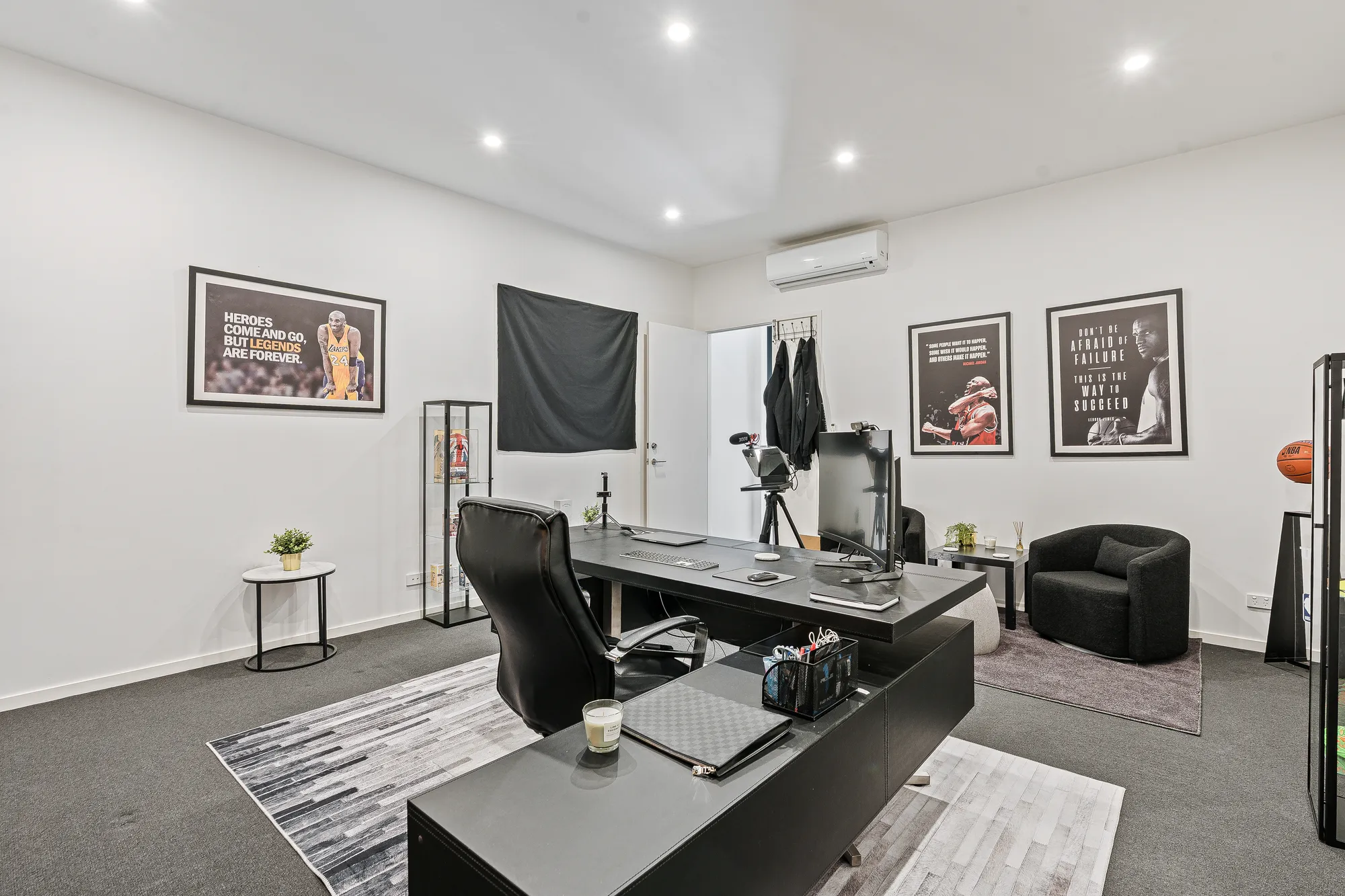 The office with framed sports jerseys