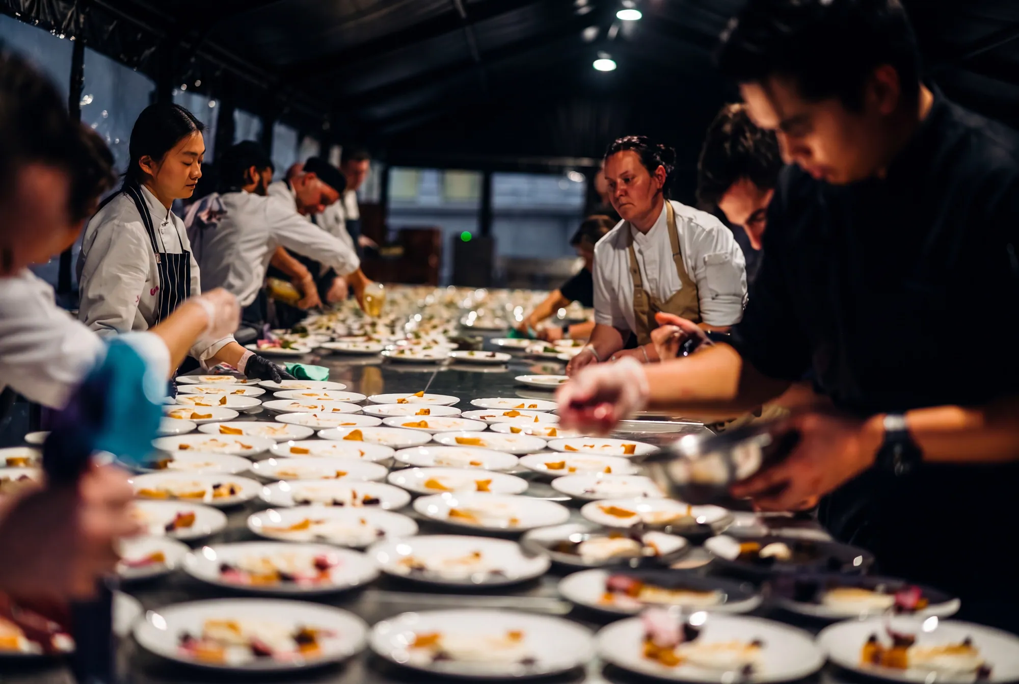 Rows of plates on the plating line as chefs work along it